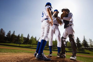 baseball players meeting at the mound