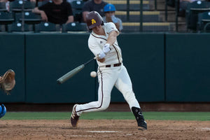 baseball player hitting a ball